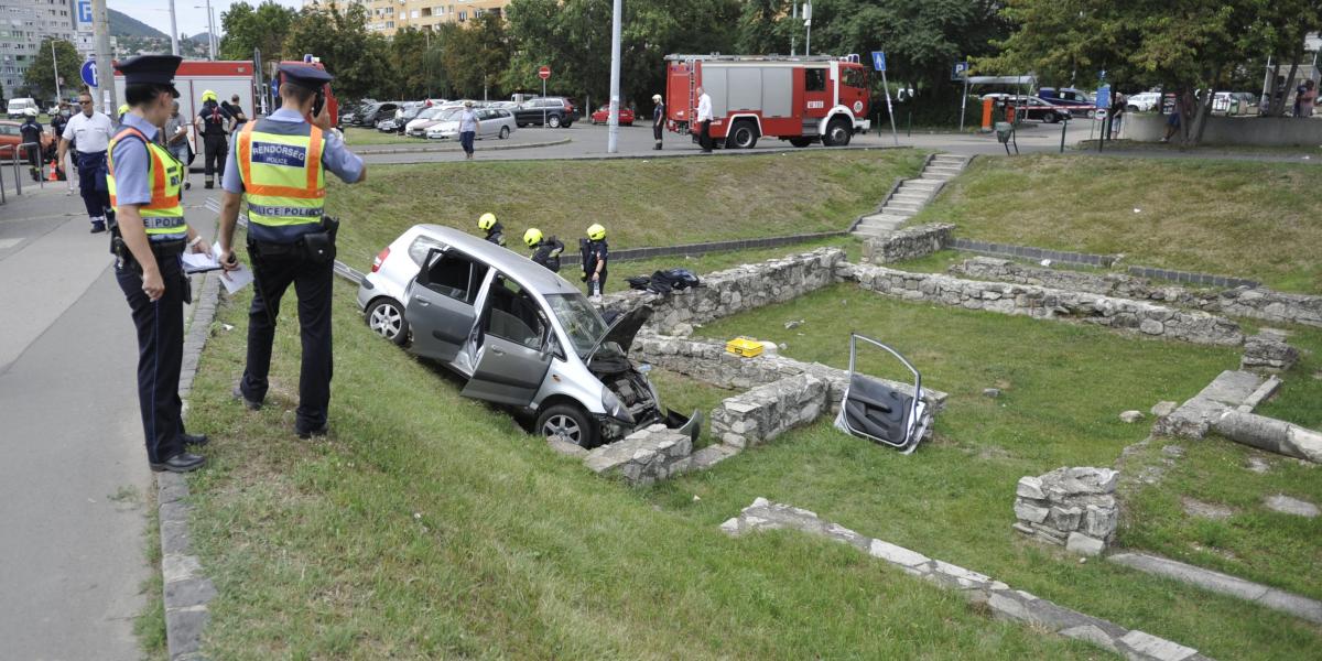 Rendőrök méregetik a romok között landoló autót a fővárosi Flórián téren, 2020. július 29-én