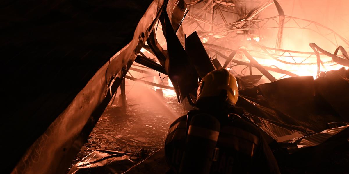 Tűzoltók oltják a tüzet egy kertészet épületénél Budapest XXIII. kerületében, Soroksáron