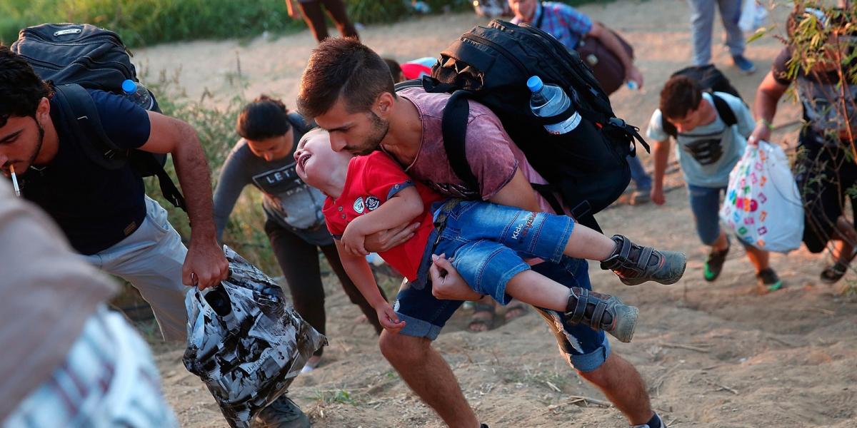 Ő még él -  Egy síró szíriai kisfiú, apjával a görög/macedón határon Fotó: Win McNamee / Getty Images