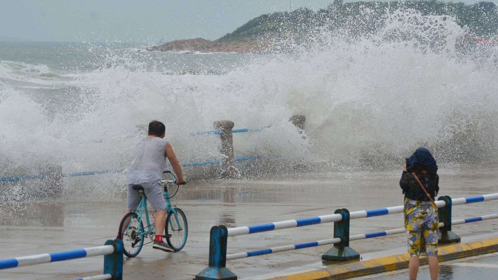 Holidaymakers brave huge waves caused by Typhoon Lekima in east China