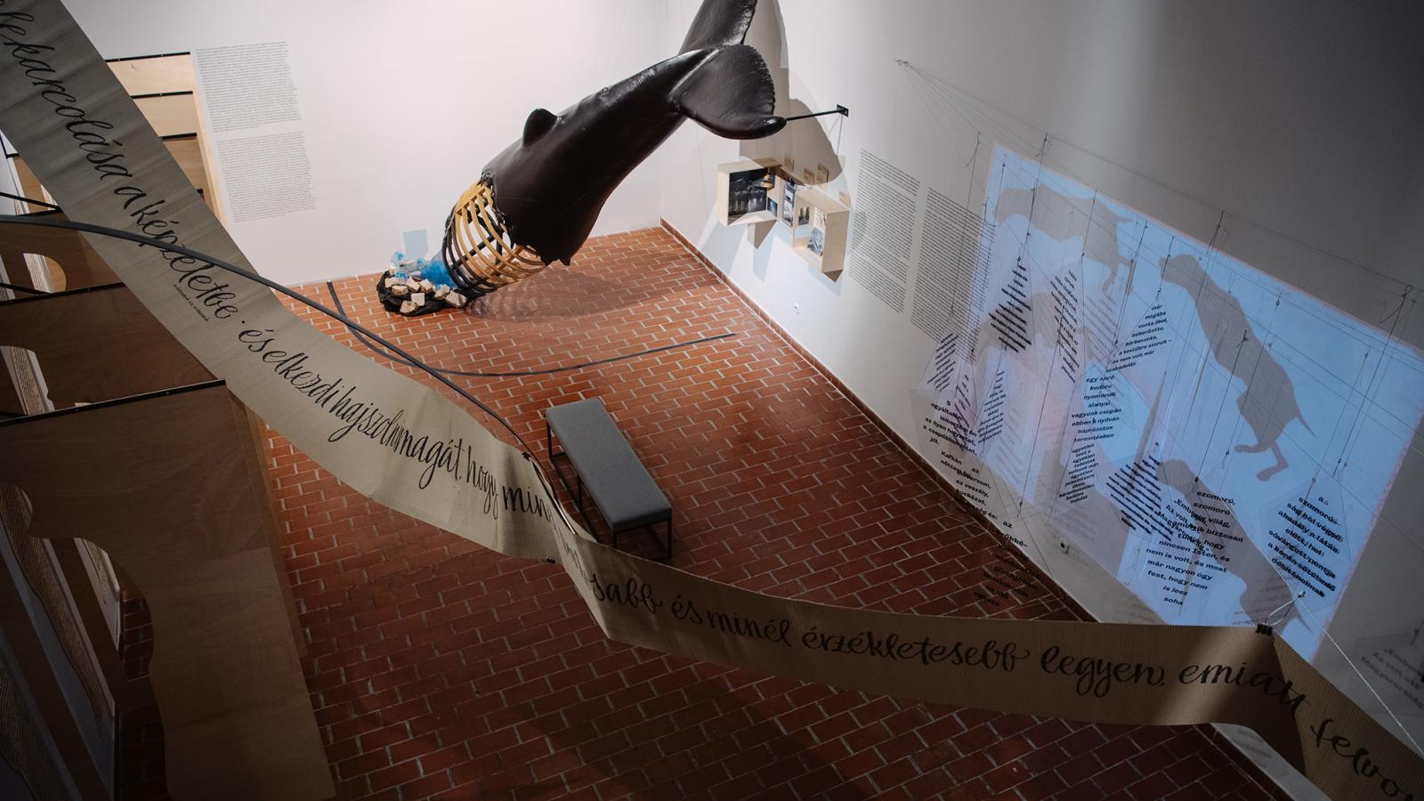 A kiállítótérben láthatjuk Az ellenállás melankóliája című regény ihlette Valuska című opera színpadi bálnáját is