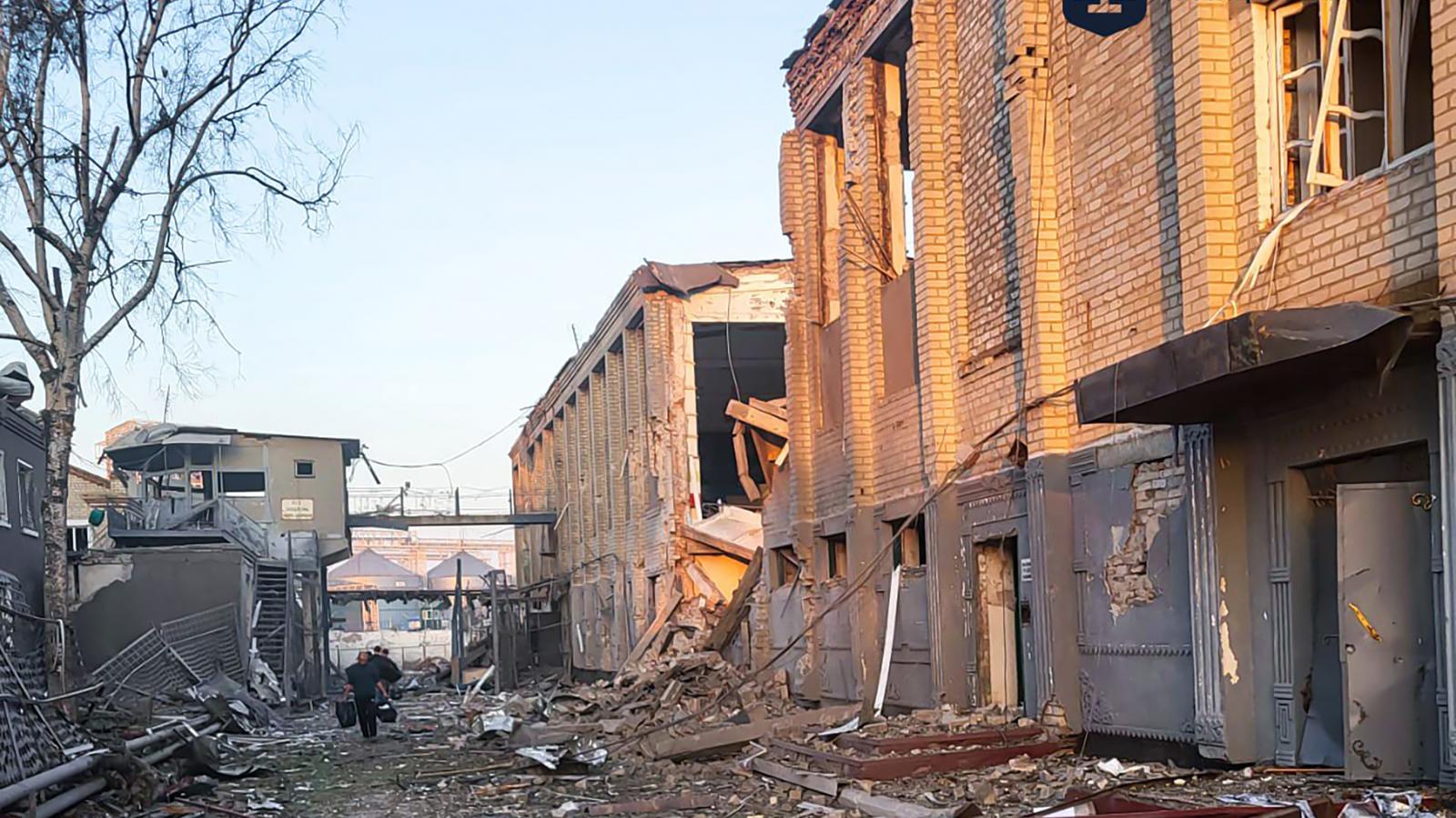 A büntetés-végrehajtási intézet romjai között sétál egy férfi, miután légitámadás érte a délkelet-ukrajnai Zaporizzsja régióban található büntetőtábort